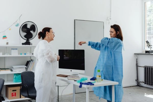 Researchers wearing laboratory safety PPE gear
