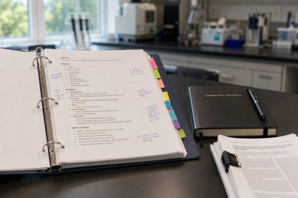 Open protocol binder with annotated NAD+ research procedures